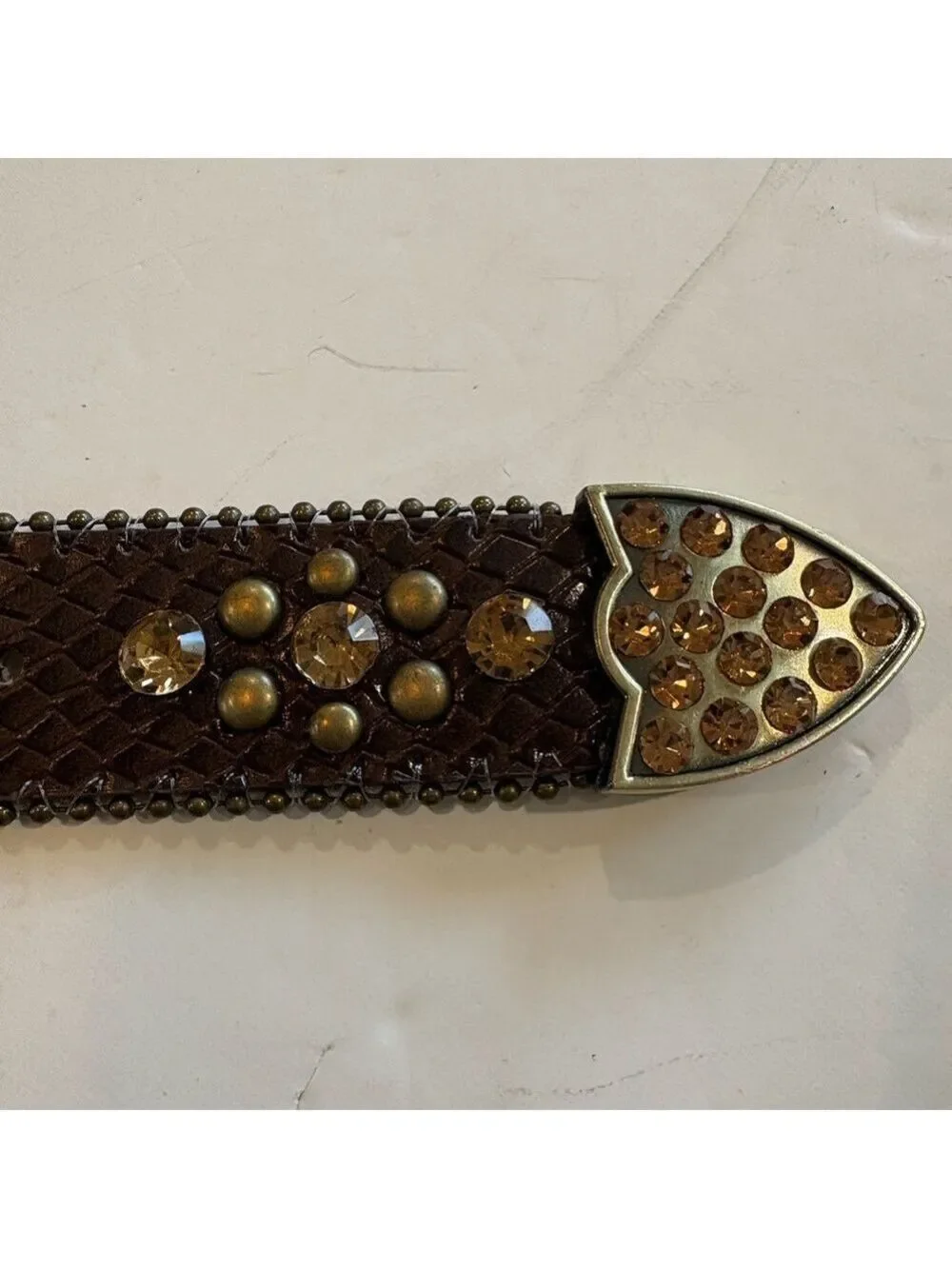Brown leather belt adorned with amber stones and burnished gold studs. Size 24
